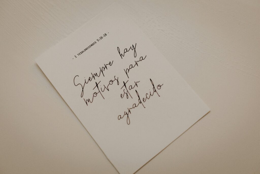 Minimalist photo of an inspirational calligraphy note on white paper.